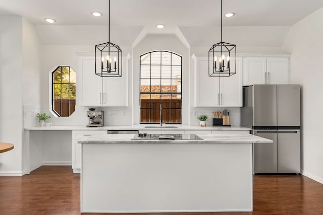 kitchen with dark wood finished floors, white cabinets, a notable chandelier, and freestanding refrigerator