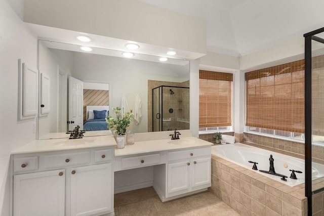 ensuite bathroom with a sink, a stall shower, double vanity, and connected bathroom