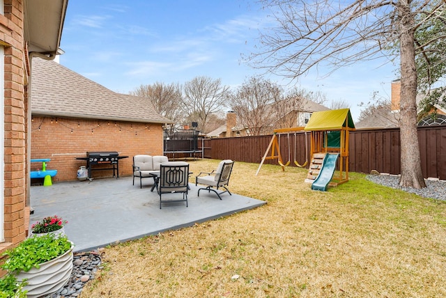 view of yard with a fenced backyard, a trampoline, a playground, and a patio