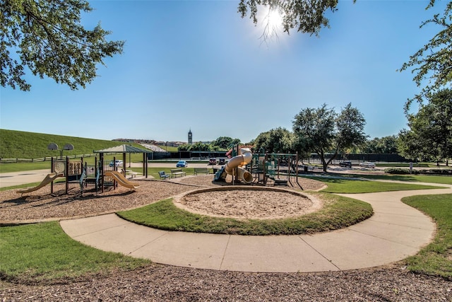 exterior space featuring playground community and a yard