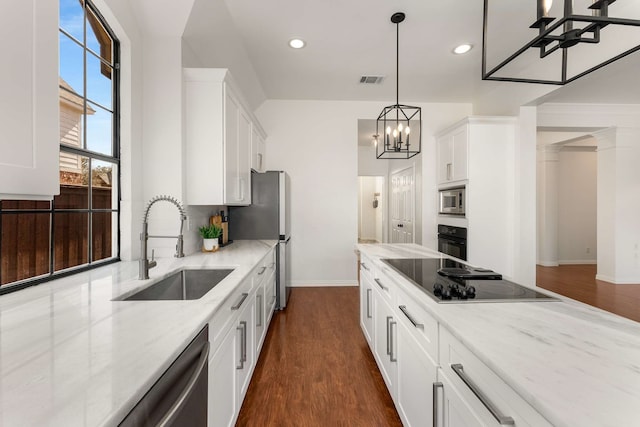 kitchen with dark wood-type flooring, white cabinets, a sink, and black appliances