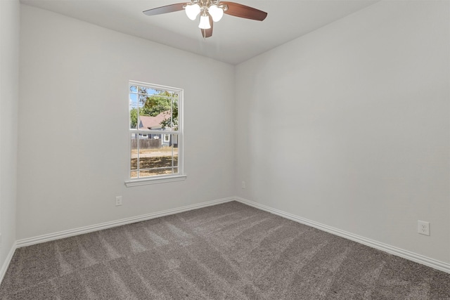 empty room with carpet, baseboards, and a ceiling fan