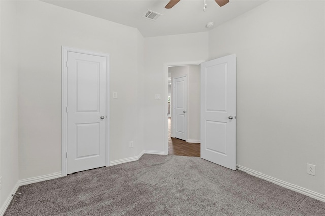 unfurnished bedroom with ceiling fan, carpet flooring, visible vents, and baseboards