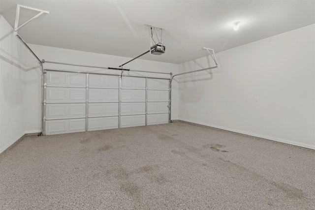 garage with a garage door opener and baseboards