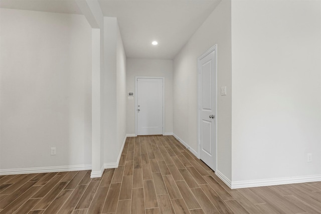 hall with recessed lighting, baseboards, and wood finish floors