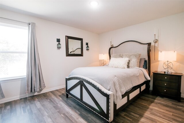 bedroom with dark wood-style floors and baseboards