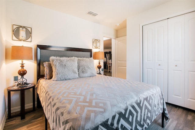 bedroom featuring a closet, visible vents, and wood finished floors