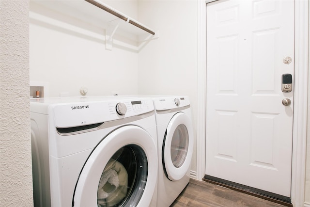 laundry area with laundry area, dark wood-style flooring, and separate washer and dryer