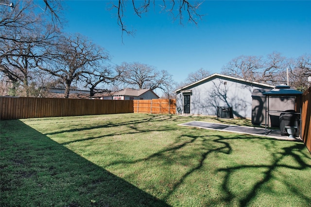 view of yard featuring a fenced backyard, a patio, and central air condition unit