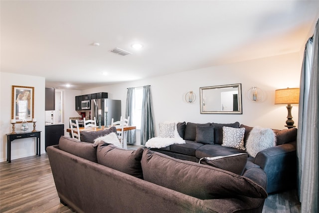 living area with recessed lighting, dark wood-style flooring, and visible vents