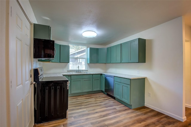 kitchen with range, dishwasher, light wood-style flooring, black microwave, and green cabinetry