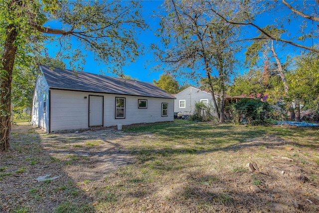 back of property featuring a yard