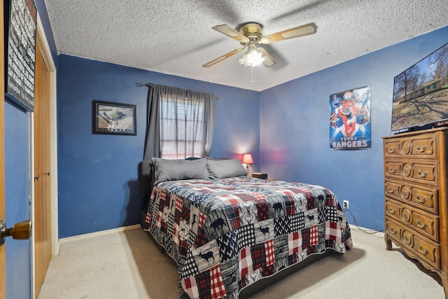 carpeted bedroom with a textured ceiling, ceiling fan, and baseboards