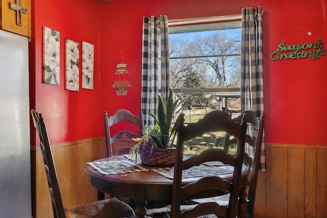 dining room featuring wood walls and wainscoting