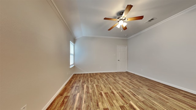 unfurnished room featuring visible vents, light wood-style floors, ornamental molding, a ceiling fan, and baseboards