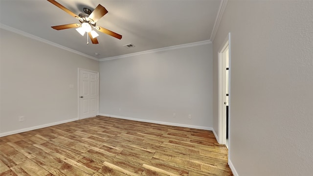 empty room with light wood-type flooring, baseboards, visible vents, and crown molding