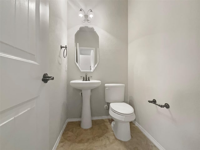 bathroom with tile patterned floors, toilet, and baseboards