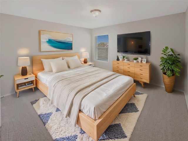 bedroom with light colored carpet and baseboards