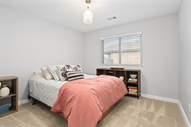 bedroom with light colored carpet, visible vents, and baseboards