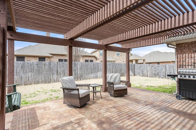 view of patio featuring a fenced backyard, a pergola, and grilling area