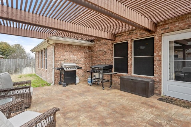 view of patio / terrace with area for grilling, a pergola, and fence