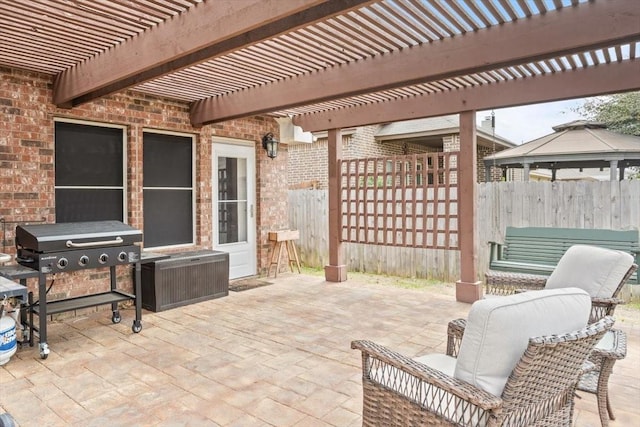 view of patio / terrace featuring a gazebo, fence, and grilling area