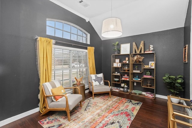 sitting room with vaulted ceiling, visible vents, baseboards, and wood finished floors