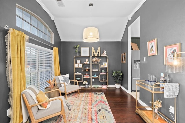 living area featuring visible vents, crown molding, baseboards, and wood finished floors