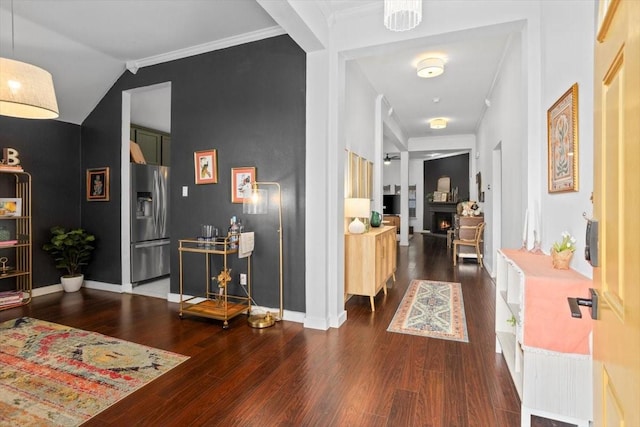 corridor featuring crown molding, baseboards, and dark wood-style flooring