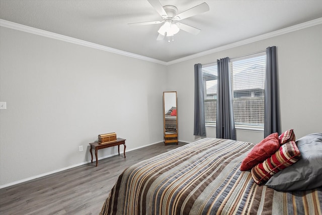 bedroom with ceiling fan, ornamental molding, wood finished floors, and baseboards