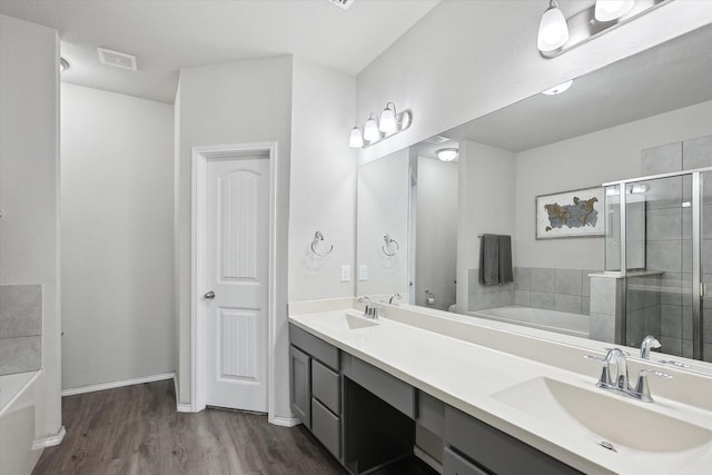 bathroom with visible vents, a sink, and a bath