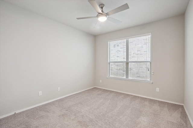 unfurnished room featuring baseboards, a ceiling fan, and carpet flooring