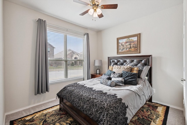 bedroom with a ceiling fan, baseboards, and carpet flooring