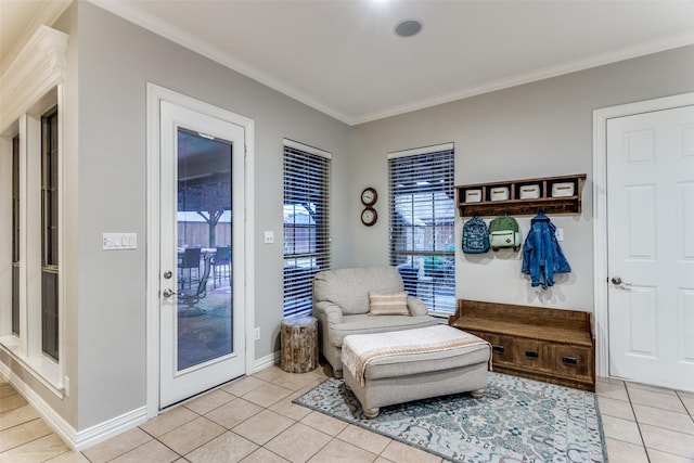 mudroom with ornamental molding, light tile patterned flooring, and baseboards