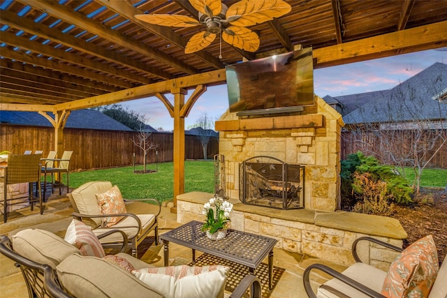 view of patio with a fenced backyard and an outdoor living space with a fireplace