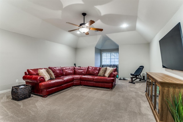 living room featuring light carpet, baseboards, a ceiling fan, and lofted ceiling