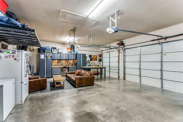 garage featuring a garage door opener and freestanding refrigerator