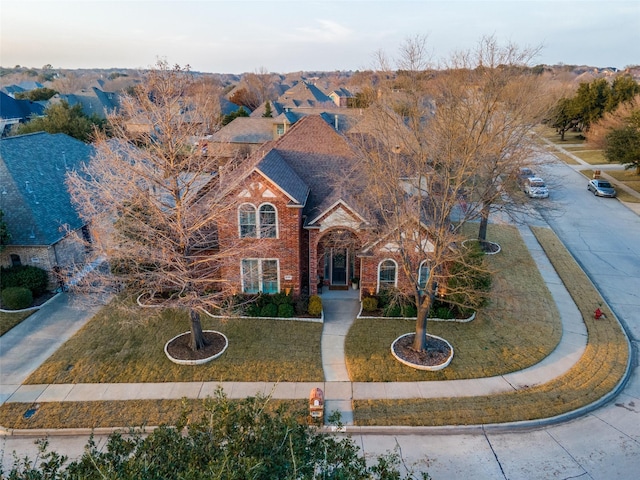 view of front of home with brick siding and a front yard