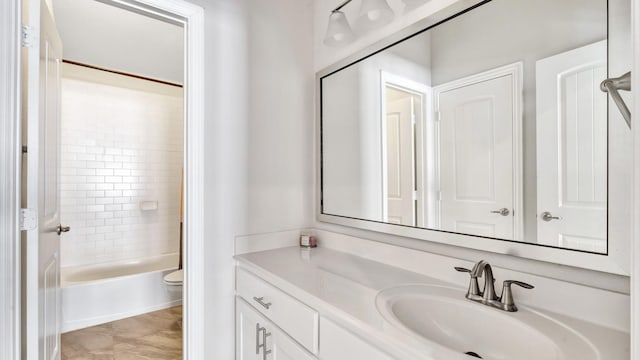 bathroom with shower / bath combination, vanity, and toilet