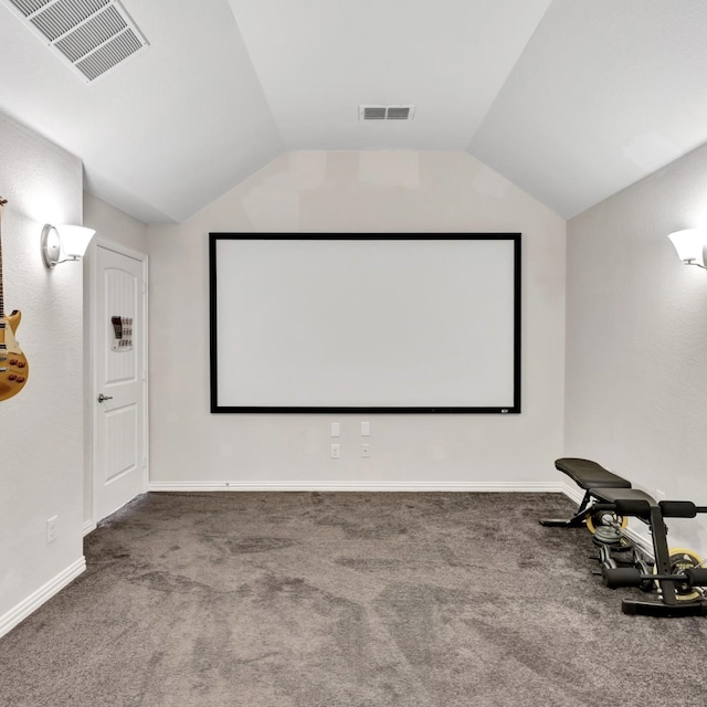 cinema room featuring carpet floors, lofted ceiling, and visible vents