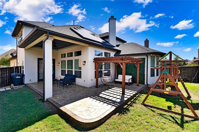 rear view of property with a playground, a fenced backyard, stucco siding, a pergola, and a patio area