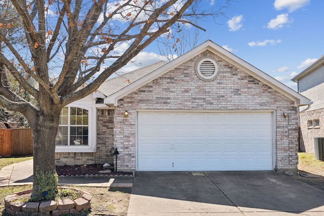 single story home featuring driveway, a garage, fence, and brick siding