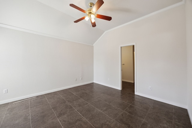 empty room with lofted ceiling, ceiling fan, dark tile patterned floors, baseboards, and crown molding