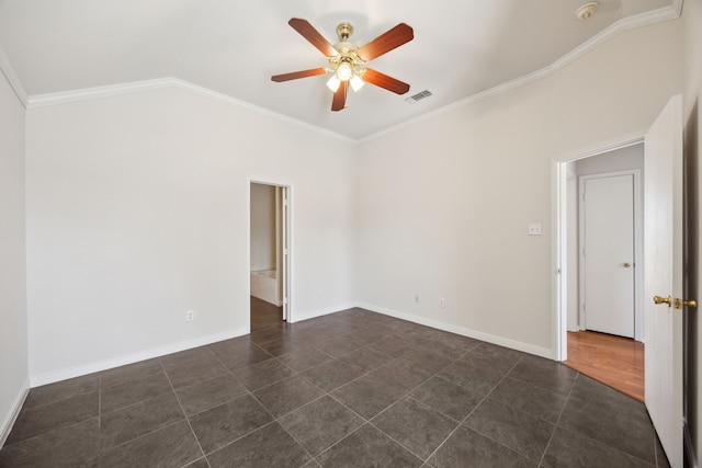 empty room with baseboards, visible vents, a ceiling fan, dark tile patterned flooring, and crown molding