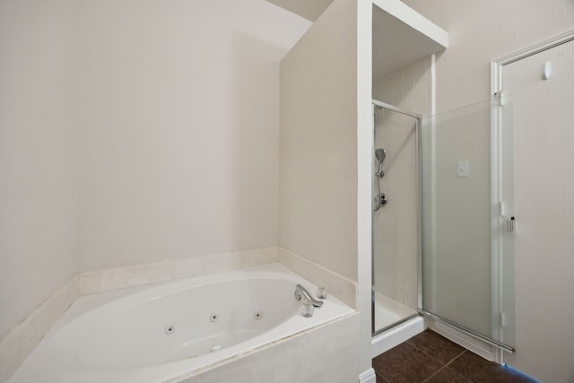 bathroom featuring a whirlpool tub, a shower stall, and tile patterned floors