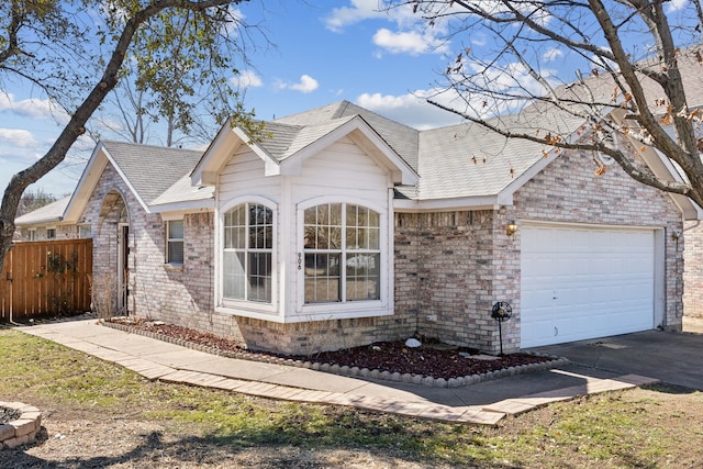 ranch-style home featuring driveway, an attached garage, fence, and brick siding