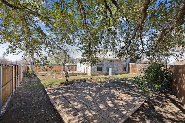 exterior space with a patio, brick siding, and a fenced backyard