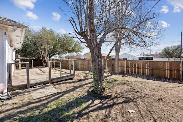 view of yard with a fenced backyard and a wooden deck