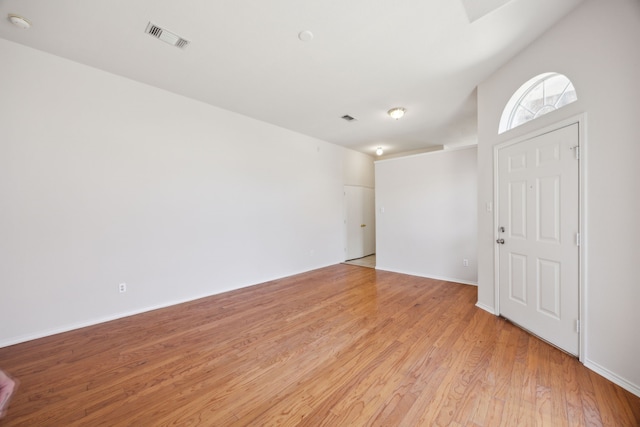 unfurnished room with light wood-type flooring, baseboards, and visible vents