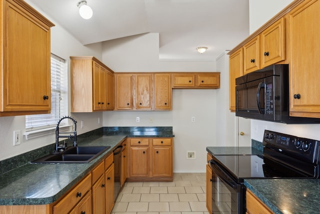 kitchen featuring dark countertops, brown cabinets, a sink, and black appliances